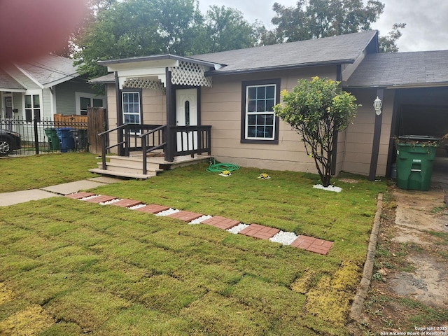 ranch-style home featuring a front yard and fence