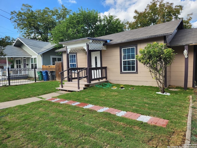 ranch-style house featuring a front lawn and fence