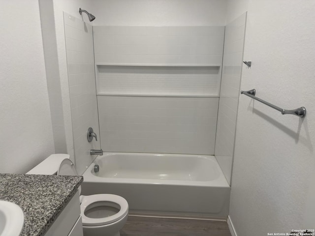 full bath featuring toilet, vanity, bathing tub / shower combination, and wood finished floors