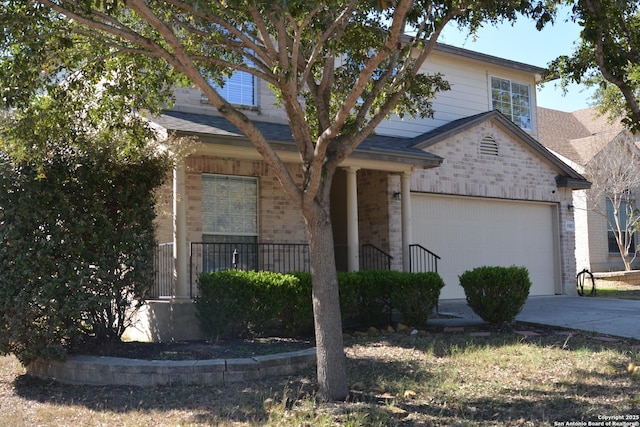 view of front facade with brick siding, a porch, concrete driveway, and a garage