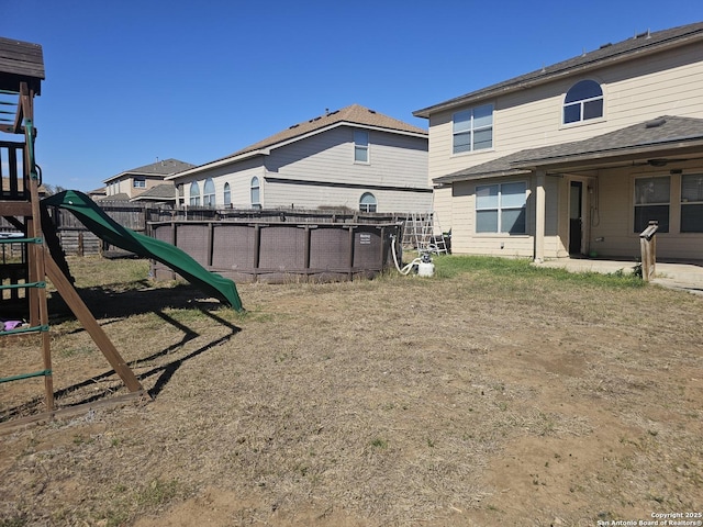 view of yard featuring a playground and fence