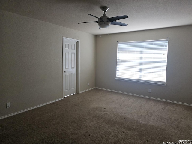 carpeted empty room with baseboards and ceiling fan