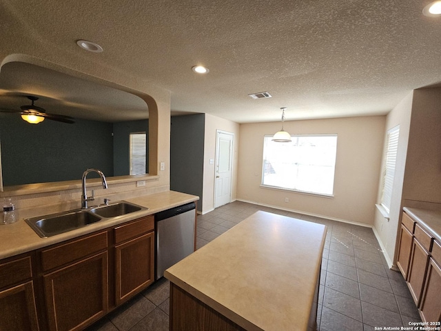 kitchen with visible vents, ceiling fan, a sink, light countertops, and stainless steel dishwasher