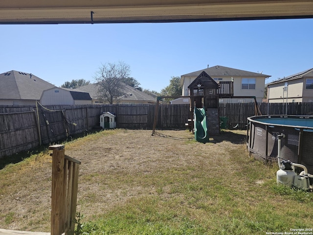 view of yard featuring a playground and a fenced backyard