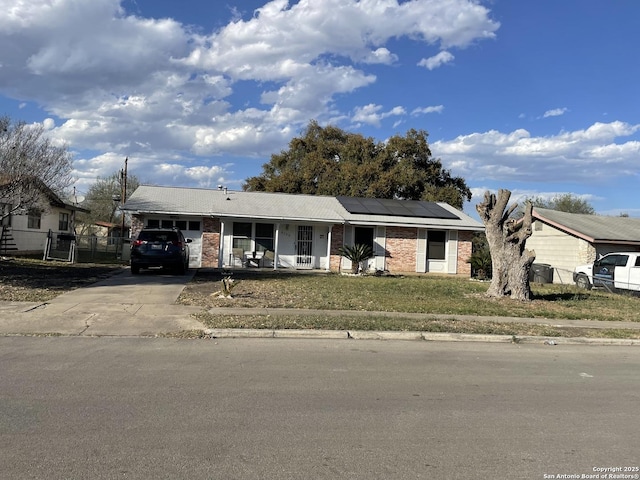 single story home with fence, a porch, concrete driveway, a carport, and brick siding