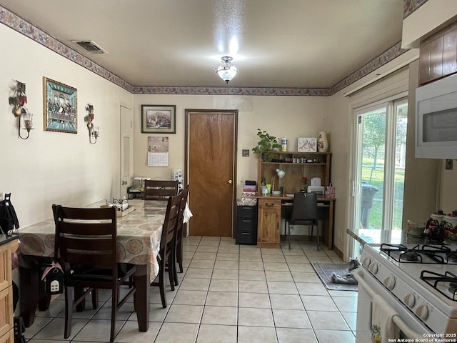 dining area with light tile patterned flooring and visible vents