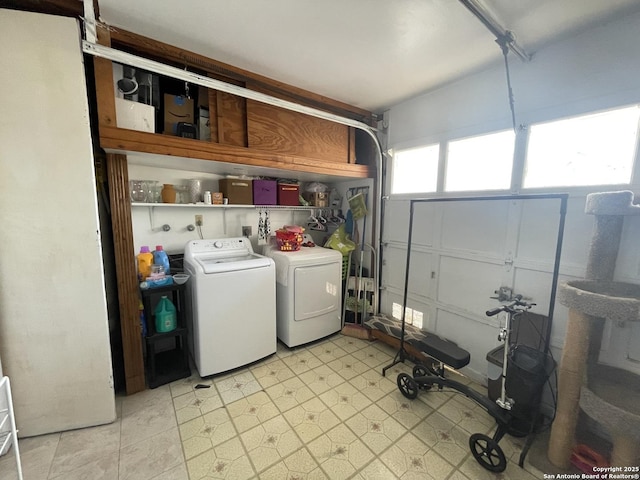 laundry area featuring laundry area, light floors, a garage, and separate washer and dryer