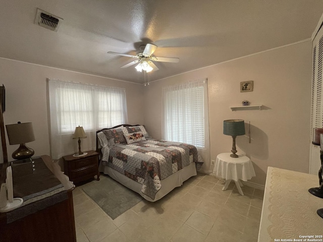 bedroom featuring light tile patterned floors, baseboards, visible vents, ceiling fan, and crown molding