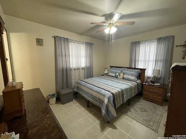 bedroom with light tile patterned floors and ceiling fan