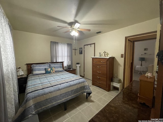 bedroom with light tile patterned floors, visible vents, and ceiling fan