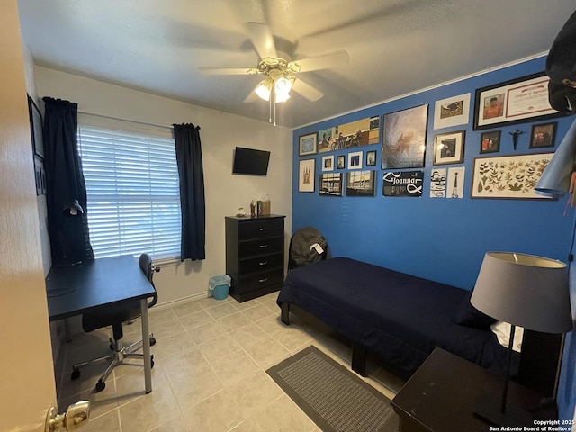 bedroom featuring baseboards and ceiling fan