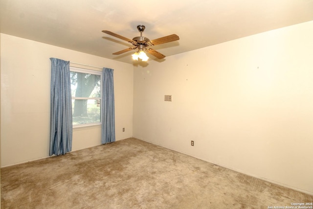 carpeted spare room featuring ceiling fan