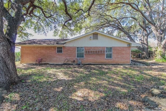 view of property exterior with brick siding