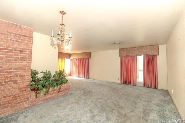 carpeted spare room featuring an inviting chandelier