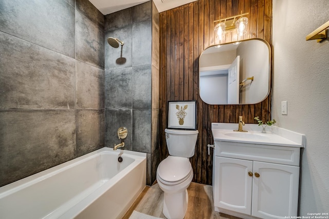 full bathroom featuring shower / bathtub combination, toilet, vanity, and wood finished floors