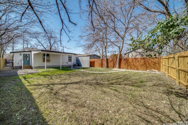 view of yard with a fenced backyard and entry steps