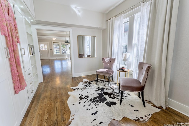 living area featuring baseboards and wood finished floors