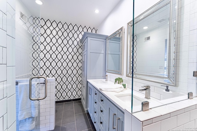 full bathroom with tile patterned flooring, visible vents, double vanity, recessed lighting, and a sink