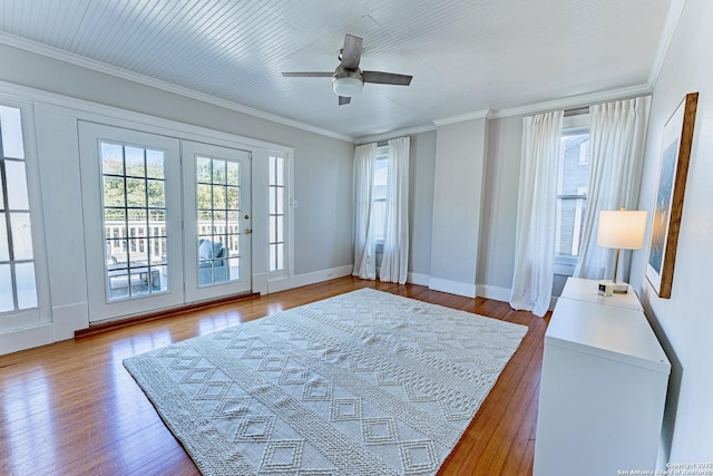 bedroom featuring baseboards, ceiling fan, wood-type flooring, crown molding, and access to outside