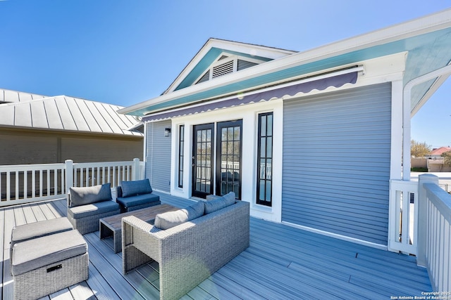 wooden deck with an outdoor living space and french doors