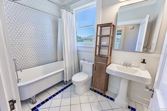 full bathroom featuring tile patterned floors, toilet, shower / tub combo, and a sink