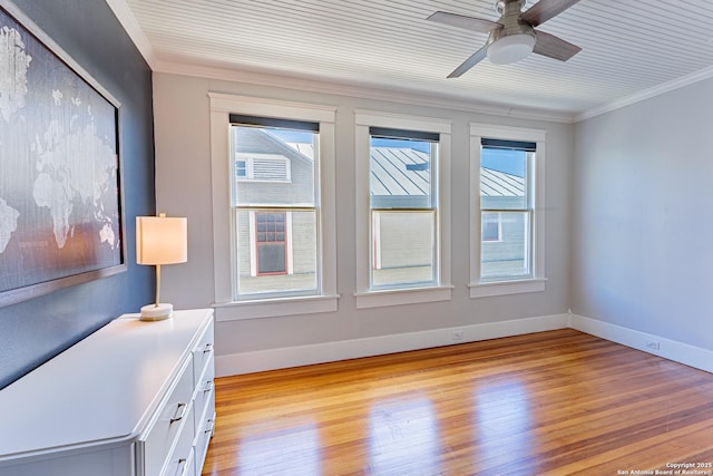 interior space with crown molding, light wood-style flooring, and baseboards