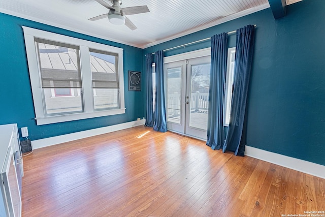 unfurnished room with ceiling fan, baseboards, and hardwood / wood-style floors