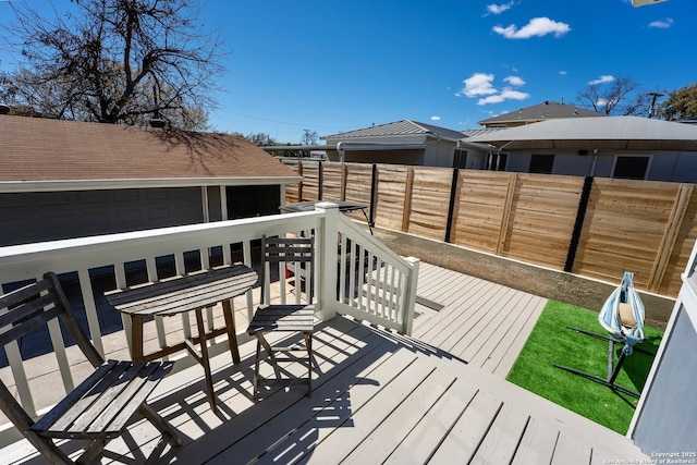 wooden terrace featuring fence