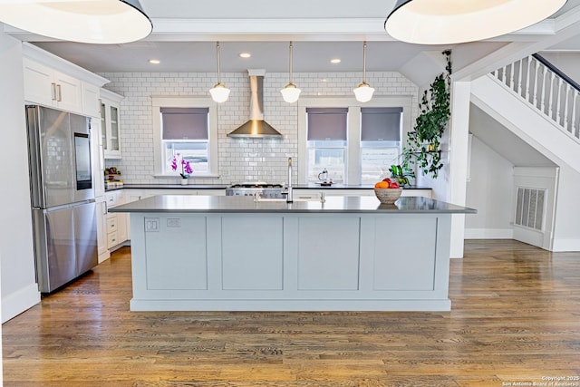 kitchen featuring visible vents, dark wood finished floors, smart refrigerator, dark countertops, and wall chimney exhaust hood