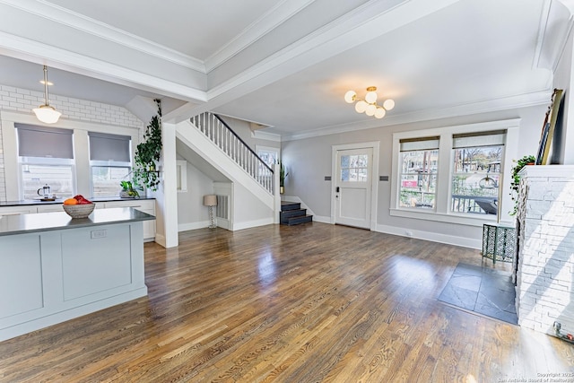 foyer featuring crown molding, stairway, dark wood-style floors, and baseboards