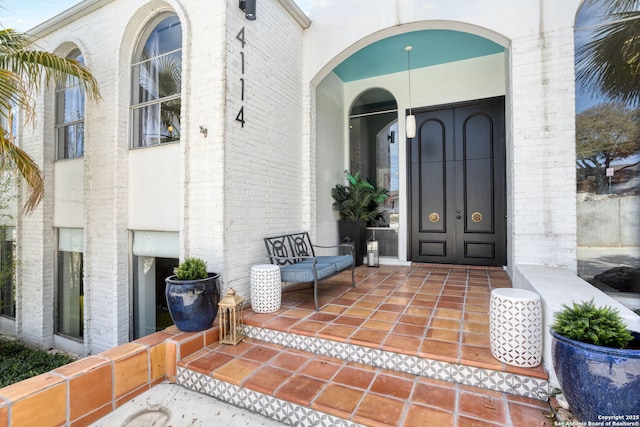 property entrance featuring brick siding