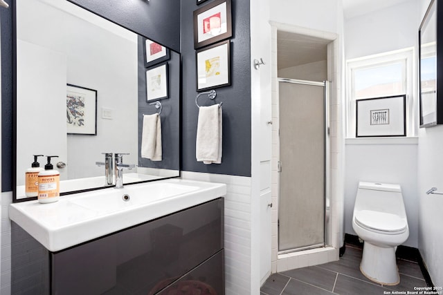 bathroom with vanity, a shower stall, and toilet