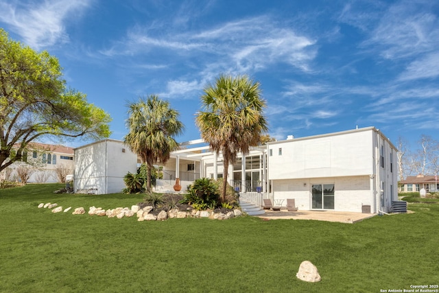 back of house featuring a patio and a yard