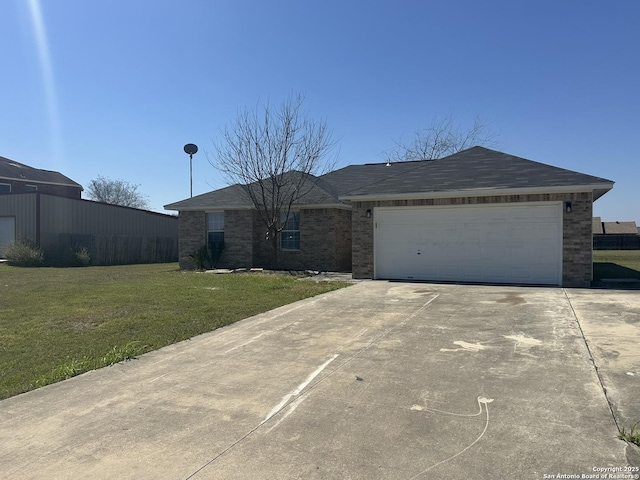 ranch-style home with brick siding, a front lawn, an attached garage, and driveway