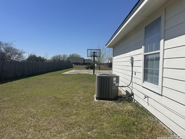 view of yard featuring central air condition unit and fence