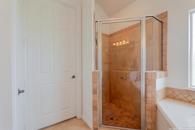 bathroom with tile patterned flooring, a shower stall, and a garden tub