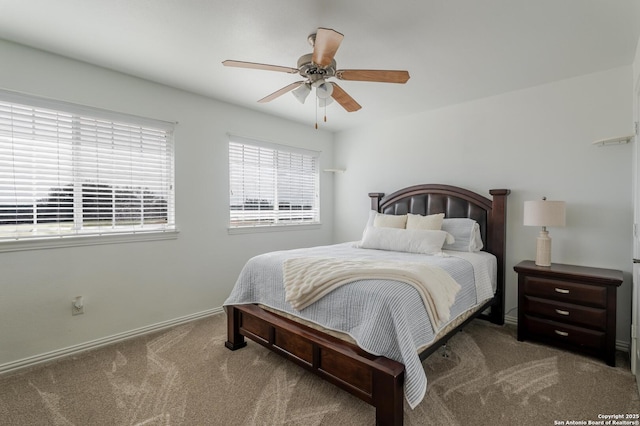 carpeted bedroom featuring baseboards and a ceiling fan