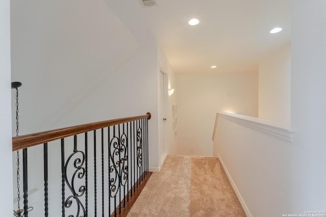 corridor featuring visible vents, an upstairs landing, recessed lighting, carpet floors, and baseboards