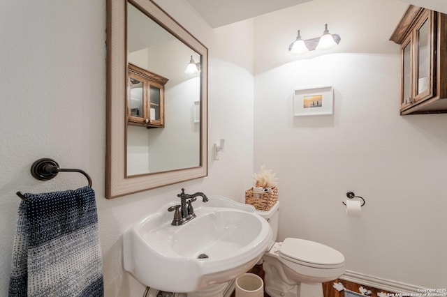 bathroom with toilet and a sink