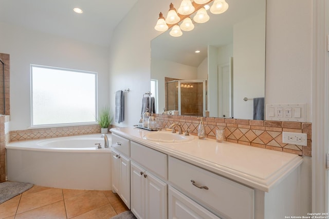 bathroom with tile patterned floors, lofted ceiling, vanity, and a shower stall