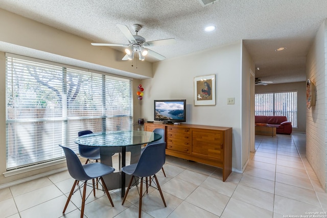 dining room featuring light tile patterned floors, plenty of natural light, and ceiling fan