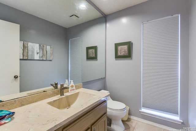 bathroom featuring tile patterned flooring, visible vents, toilet, and vanity