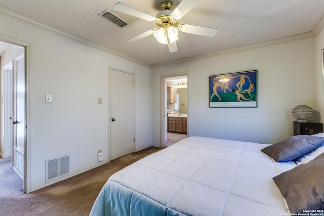 carpeted bedroom with visible vents, ensuite bathroom, a textured ceiling, and crown molding
