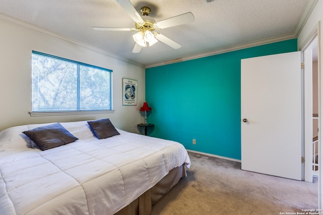 carpeted bedroom with a textured ceiling, a ceiling fan, and ornamental molding