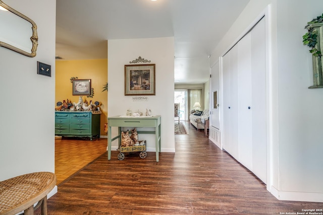 hall with parquet floors and baseboards