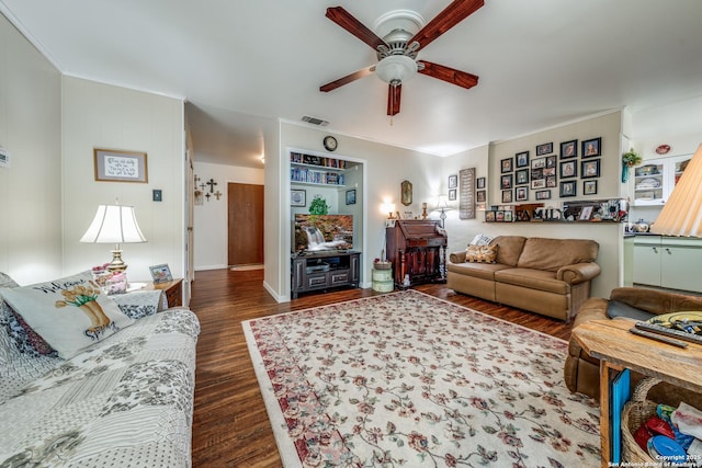 living room featuring dark wood finished floors, visible vents, and ceiling fan