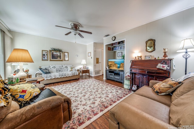 living area featuring visible vents, wood finished floors, and a ceiling fan