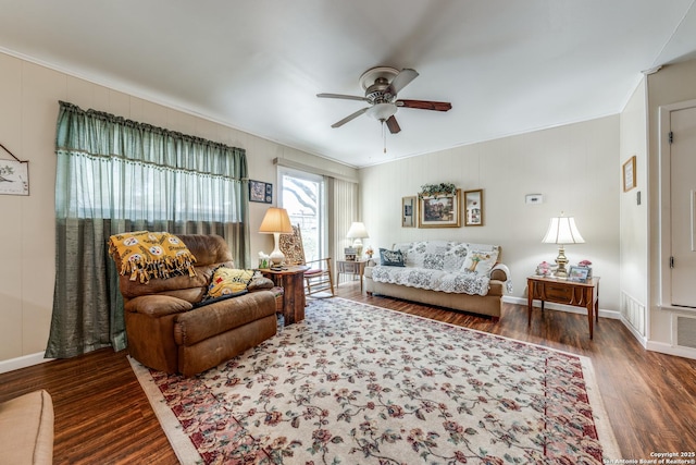 living room with visible vents, wood finished floors, baseboards, and ceiling fan