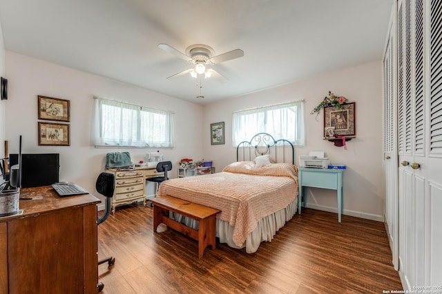 bedroom featuring a ceiling fan, wood finished floors, and baseboards