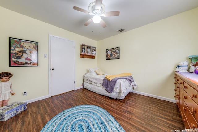 bedroom with ceiling fan, visible vents, baseboards, and wood finished floors